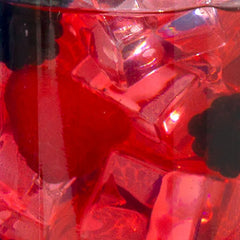 Close-up of a red plastic bag with a clear plastic container inside, filled with red objects.