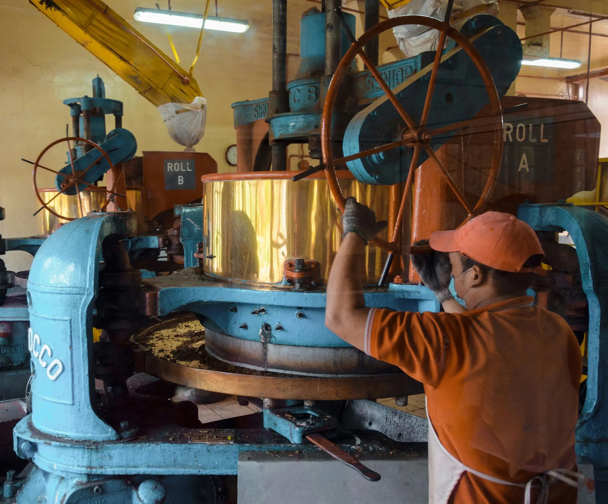 Person operating large industrial machinery in a factory setting