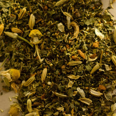 Close-up of dried herbs and flowers on a white surface