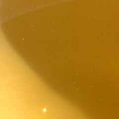 Close-up of a yellowish-brown liquid with a gradient effect