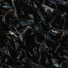 Close-up of dark brown dried tea leaves